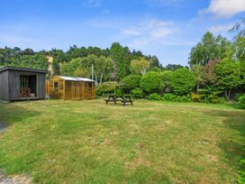 A garden with two sheds and a picnic table at Raisin Town - Marahau Bach Marahau