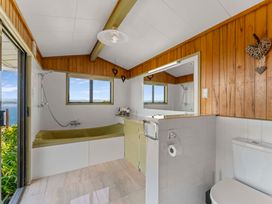 A bathroom featuring a bathtub, sink, and toilet at Heights Haven - Acacia Bay Holiday Home, Acacia Bay