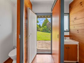 A bathroom with a toilet and sink at Heights Haven - Acacia Bay Holiday Home Acacia Bay
