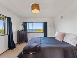 A bedroom with a bed and dresser at Heights Haven - Acacia Bay Holiday Home Acacia Bay