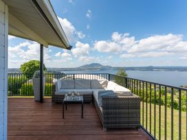 A balcony with outdoor furniture at Heights Haven - Acacia Bay Holiday Home in Acacia Bay