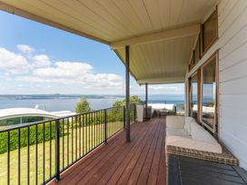 A balcony with seating and a view at Heights Haven - Acacia Bay Holiday Home Acacia Bay