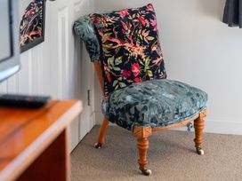 A chair with a decorative pillow at Lake Magic - Motuoapa Holiday Home, Motuoapa