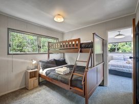 A bedroom with a bunk bed and a nightstand at Central Spacious Family House - Paihia