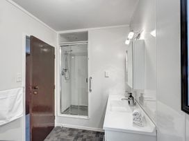 A bathroom with a shower and vanity at Central Spacious Family House - Paihia