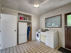A laundry room with appliances and storage at Central Spacious Family House - Paihia