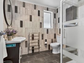 A bathroom featuring a sink, toilet, and shower at Little Pearl of Vista Verano - Mangawhai Village