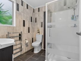A bathroom with a toilet and shower at Little Pearl of Vista Verano - Mangawhai Village