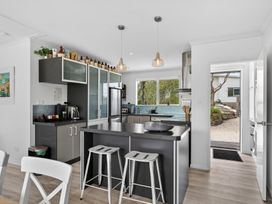 A kitchen with appliances and a counter at Little Pearl of Vista Verano - Mangawhai Village