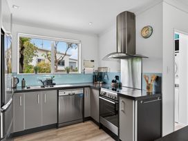 A kitchen with sink and stove at Little Pearl of Vista Verano - Mangawhai Village