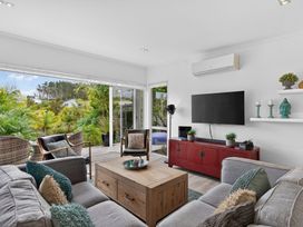 A living room with a coffee table and television at Little Pearl of Vista Verano - Mangawhai Village