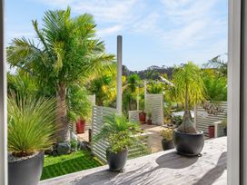 An outdoor area with palm trees and planters at Little Pearl of Vista Verano - Mangawhai Village