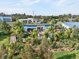 A house with a garden and patio at Little Pearl of Vista Verano - Mangawhai Village