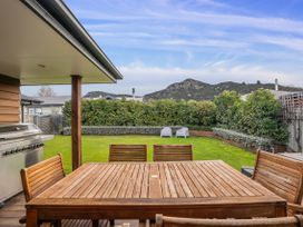 A garden with a dining table and barbecue area at Albert Town Wanaka Oasis - Wanaka
