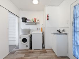 A laundry room with a washing machine and dryer at Wharewaka Bach - Lake Taupo Holiday Home Wharewaka