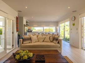 A living room with a sofa and coffee table at Moa Magic - Oneroa Holiday Home Oneroa