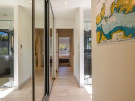 A hallway with a shower and map at Moa Magic - Oneroa