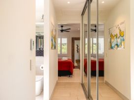 A bedroom with a bed and towels at Moa Magic - Oneroa Holiday Home Oneroa