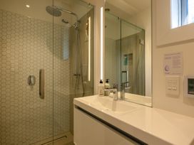 A bathroom with a shower and sink at Moa Magic - Oneroa Holiday Home, Oneroa