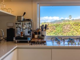 A kitchen with coffee machine and gas stove at Moa Magic - Oneroa Holiday Home Oneroa