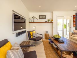 A living room with a sofa and coffee table at Moa Magic - Oneroa Holiday Home Oneroa