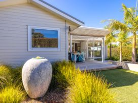 A house with a deck and plants at Moa Magic - Oneroa Holiday Home Oneroa