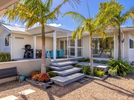 An outdoor area with steps and palm trees at Moa Magic - Oneroa Holiday Home Oneroa