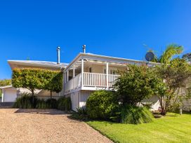 A house with a porch and garden at Moa Magic - Oneroa Holiday Home Oneroa