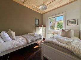 A bedroom with two beds and a dresser at Stag & 3 Pigs - Ohakune