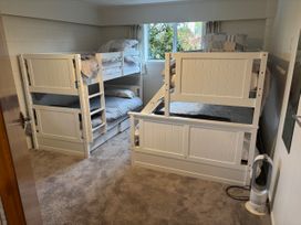 A bedroom with bunk beds and a window at Kuratau Classic - Kuratau Holiday Home