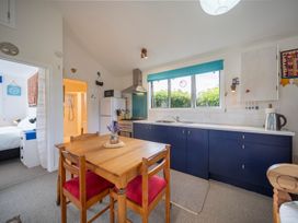 A kitchen with a dining table and chairs at Beech Retreat - Te Anau Holiday Home in Te Anau