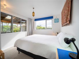 A bedroom with a bed and window at Beech Retreat - Te Anau Holiday Home in Te Anau