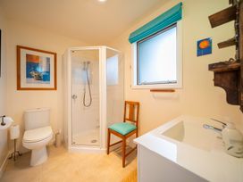 A bathroom with a shower and toilet at Beech Retreat - Te Anau Holiday Home