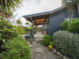 A garden with plants and pathway at Beech Retreat - Te Anau Holiday Home in Te Anau
