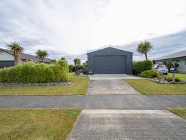 A garage and car in front of the house at Beech Retreat - Te Anau Holiday Home Te Anau