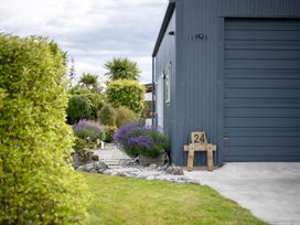 An outdoor area with a garage and lavender plants at Beech Retreat - Te Anau Holiday Home Te Anau