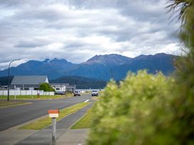 A view of mountains and a street with cars at Beech Retreat - Te Anau Holiday Home in Te Anau
