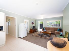 A living room with a sofa and coffee table at Camellia with WiFi - Paihia