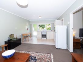 A kitchen with appliances and furniture at Camellia with WiFi - Paihia