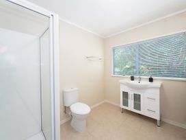 A bathroom with a shower and sink at Camellia with WiFi - Paihia