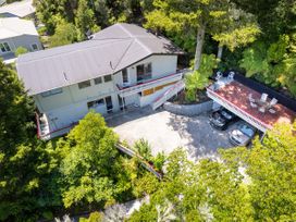 An outdoor area with a house and parking spaces at Camellia with WiFi - Paihia