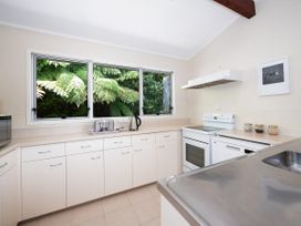 A kitchen with a stove and sink at Rimu - Paihia Holiday Home, Paihia