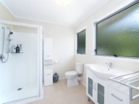 A bathroom with a shower, toilet, and sink at Rimu - Paihia Holiday Home, Paihia
