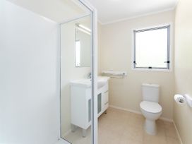 A bathroom with a sink, toilet, and shower at Rimu - Paihia Holiday Home in Paihia