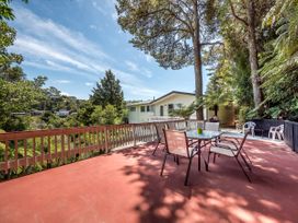 An outdoor deck with a table and chairs at Rimu - Paihia Holiday Home in Paihia