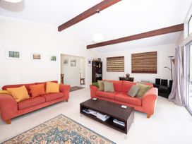 A living room with sofas and a coffee table at Rimu - Paihia Holiday Home, Paihia