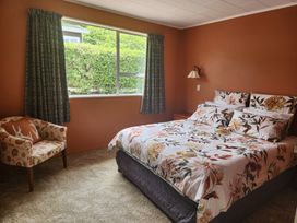 A bedroom with a bed, bedside table, and a window at The Willow - Hanmer Springs Holiday Home in Hanmer Springs
