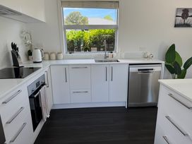 A kitchen with appliances and storage at Mahuta Maison - Lake Taupo Holiday Home Five Mile Bay