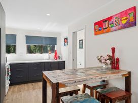 A kitchen with a table and chairs at Riverbed Lodge - Lake Taupo Home Tauranga Taupo