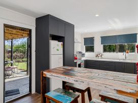 A kitchen with a table and chairs at Riverbed Lodge - Lake Taupo Home Tauranga Taupo